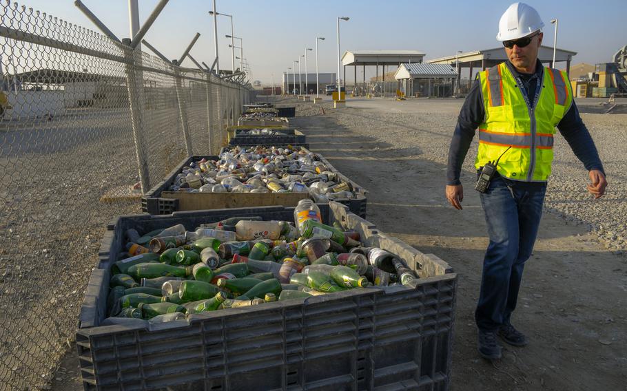 Nikola Gjorgjevikj, waste disposal supervisor at Bagram Air Field, inspects recycling bins filled with glass Dec. 14, 2018. About 70 tons of garbage is thrown out on average each day by personnel at Bagram Air Field, with around half of the daily garbage given to contractors outside the base who recycle and sell the trash.