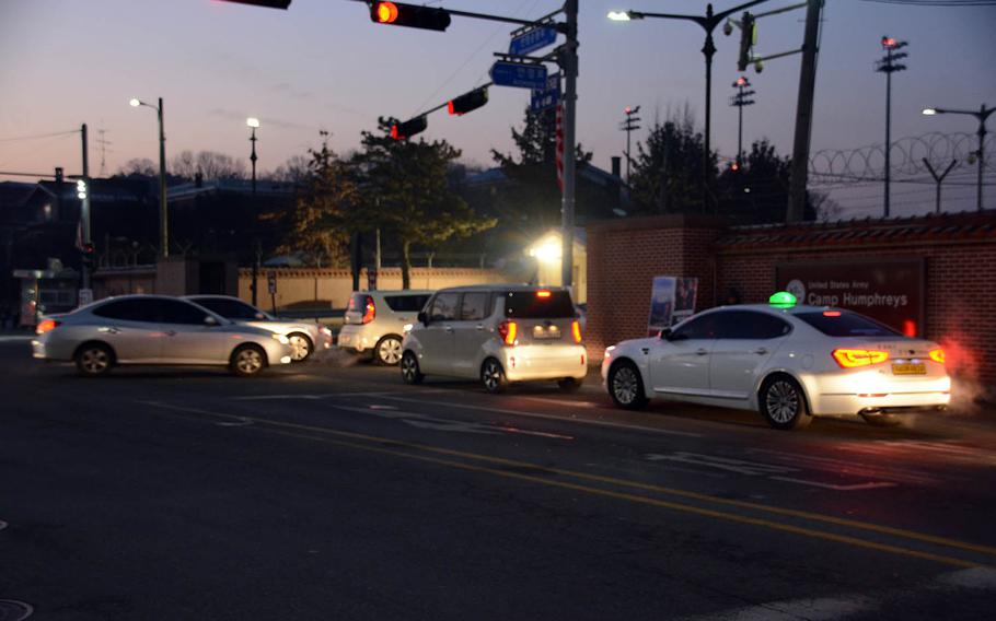 Cars line up in the morning to enter Camp Humphreys in the rural area of Pyeongtaek, South Korea, Friday, Jan. 18, 2019. Traffic jams are posing a major headache for the growing population on the recently expanded Army garrison.