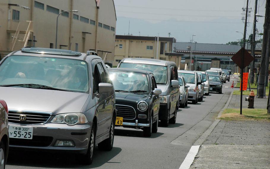 Drivers wait to cross the active runway at Yokota Air Base, Japan, in 2016. Lights control ground traffic crossing the runway, where, at any given time, one of the 374th Airlift Wing's C-130J Super Hercules transports might be landing or taking off.