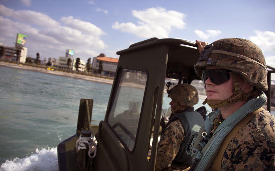 First Lt. Daniel Asheim watches Marines perform maneuvers using a bridge-erection boat during licensing operations at Naha, Okinawa, Tuesday, Jan. 29, 2019.
