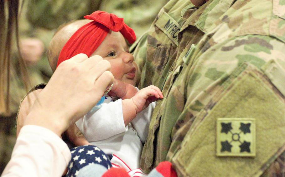 Sgt. Kristian Myrick, 23rd Infantry Regiment, meets his 3-month-old daughter, Amelia, at a welcome home ceremony at Fort Carson, Colo., Jan. 15, 2019. Army fathers now have twice as much paternity leave available.