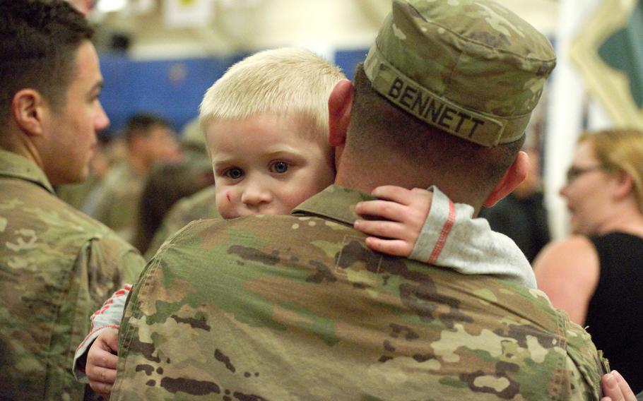 Spc. Brent Bennett,1st Cavalry Regiment, hugs his son, Lukas, following a welcome home ceremony at Fort Carson, Colo., Jan. 22, 2019. Army fathers now have twice as much paternity leave available.