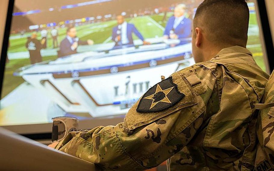 Staff Sgt. Jamie Fox of the 2nd Infantry Division watches the Super Bowl LIII pre-game show at Camp Humphreys, South Korea, Monday, Feb. 4, 2019.