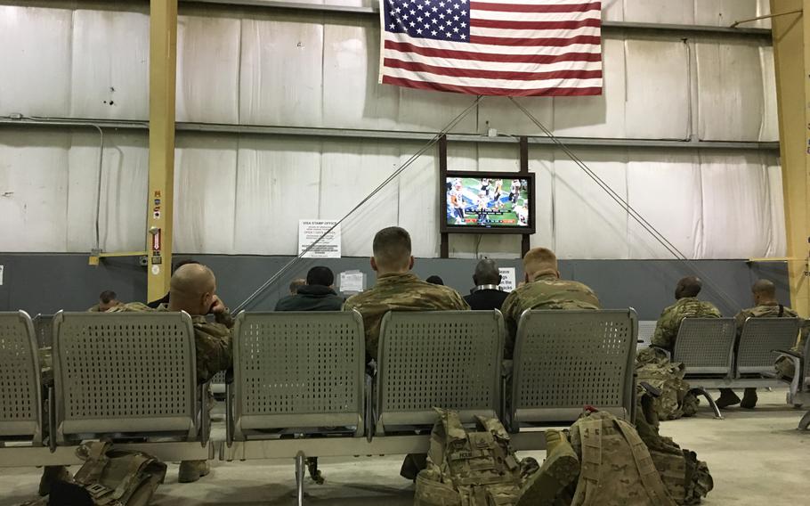 U.S. troops waiting for transport watch the Super Bowl at Bagram Air Field's rotary PAX terminal on Monday, Feb. 4, 2019.