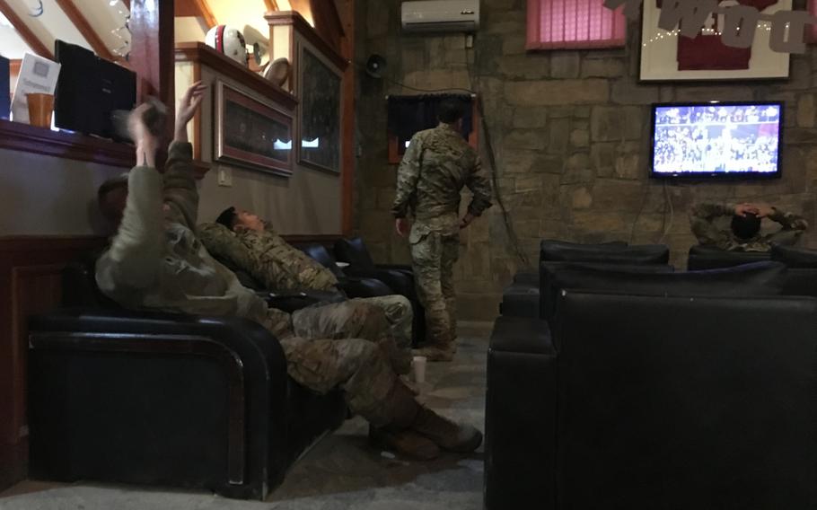 American troops stretch and yawn after watching the Super Bowl at Bagram Air Field on Monday, Feb. 4, 2019. It was 4 a.m. in Afghanistan when the game began.