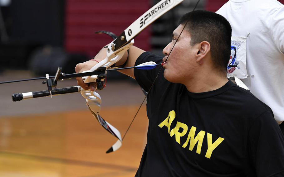 Spc. Kevin Holyan prepares to fire an arrow in the archery finals at Schofield Barracks, Hawaii, Nov. 13, 2018, during the Pacific Regional Trials hosted by the Tripler Army Medical Center's Warrior Transition Battalion and Regional Health Command - Pacific.