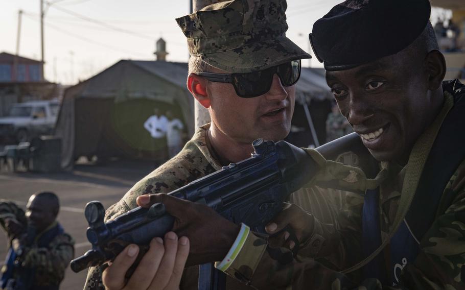 U.S. Coast Guard Chief Maritime Enforcement Specialist Sam Allen, left, provides visit, board, search and seizure training to a sailor from the Comorian navy during exercise Cutlass Express 2019 in Djibouti, Feb. 2, 2019.