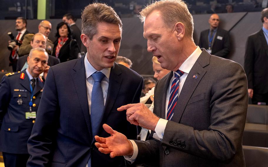 U.S. acting Defense Secretary Pat Shanahan, right, talks to his United Kingdom counterpart Gavin Williamson at the NATO defense ministerial meeting at the alliance's headquarters in Brussels, Feb. 14, 2019.