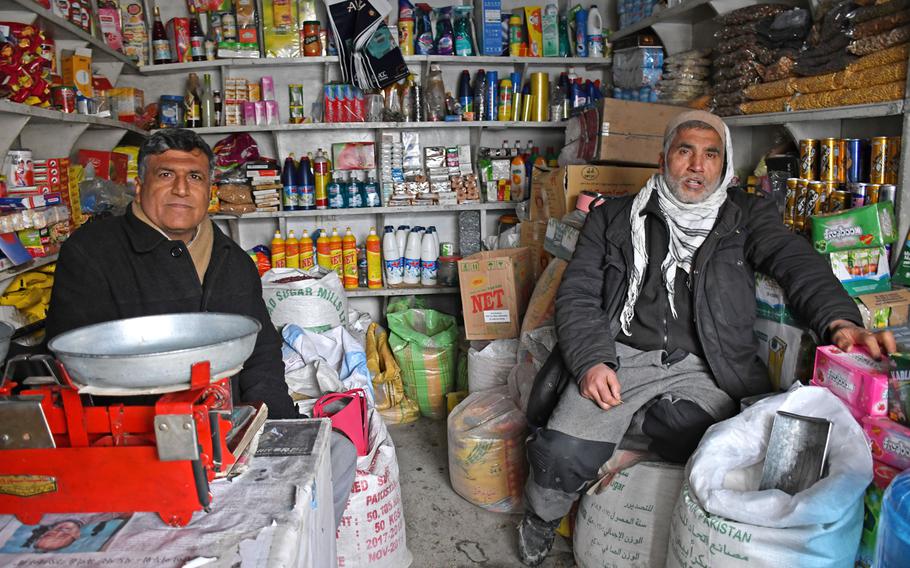 Habib Belal, left, and Qumadan sit in their small shop in central Kabul on Wednesday, Feb. 13, 2019. They fear civil war could breakout in Afghanistan if international forces withdraw hastily.