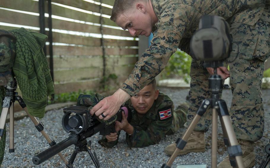 Marine Corps Sgt. Wyatt Vass instructs a Royal Thai Marine during a Cobra Gold live-fire event at Camp Ban Chan Khrem, Thailand, Feb. 13, 2019.