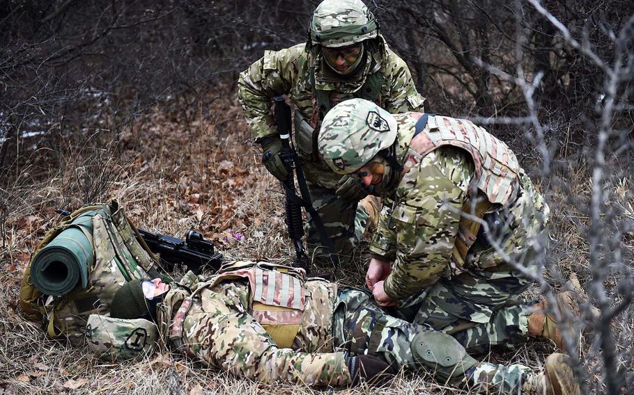 Georgian soldiers apply first aid to a mock casualty during training at the Georgia Defense Readiness Program, in Tbilisi, Georgia, Wednesday, Feb. 20, 2019. 