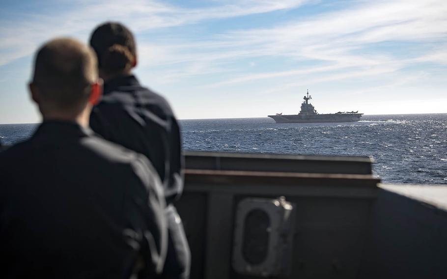 Cmdr. Matthew Powel, left, commander of the USS Donald Cook, and Cmdr. Kelley Jones, the destroyer's executive officer, watch the French aircraft carrier FS Charles De Gaulle in the Mediterranean Sea, Feb. 8, 2019.