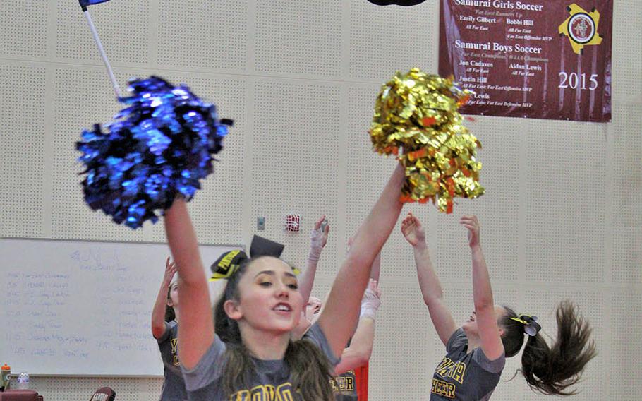 Yokota High School's Aiko Galvin is sent airborne by teammates Rorie Jenkins, Chiara Duarte and Zoe Sottosanti as Samantha Kocher cheers in the foreground during the Far East cheerleading competition at Marine Corps Air Station Iwakuni, Japan, Feb. 23, 2019.