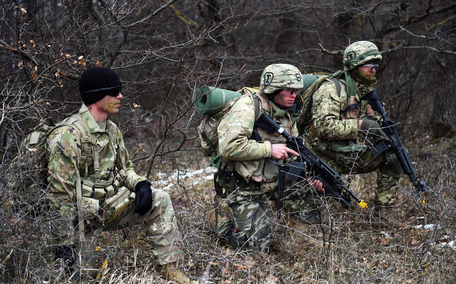 A U.S. soldier, left, observes Georgian soldiers during the Georgia Defense Readiness Program, Wednesday, Feb. 20, 2019.