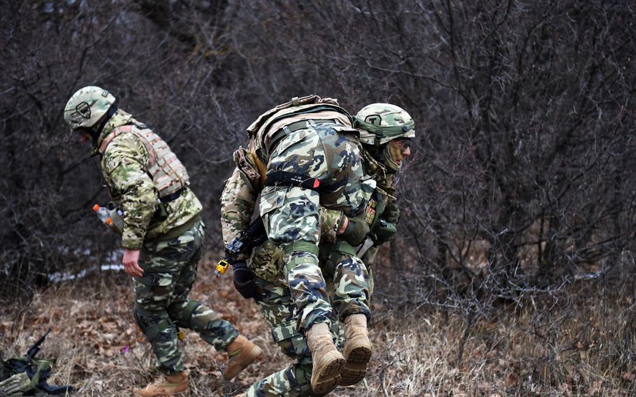 A Georgian soldier brings a mock casualty to safety during the Georgia Defense Readiness Program, Wednesday, Feb. 20, 2019.