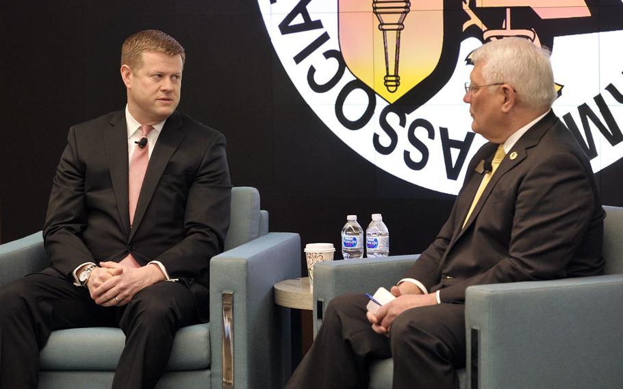 Undersecretary of the Army Ryan D. McCarthy, left, at an Association of the U.S. Army Institute of Land Warfare event on Feb.26. At right is Gen. Carter Ham, president of AUSA.