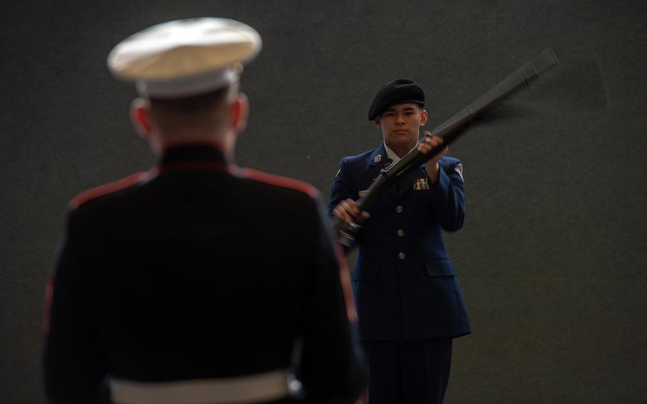 Gunnery Sgt. Matthew Nolan watches as Brandon Hwang from Aviano High School competes in the rifle solo exhibition during the DODEA-Europe JROTC drill team championships at Ramstein, Germany, Saturday, March 2, 2019.