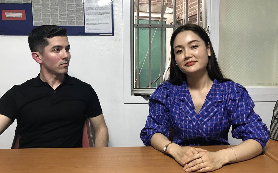 Army Capt. Matthew McGoffin listens to North Korean refugee Yuna Jung during an interview in Seoul, South Korea, March 27, 2019.