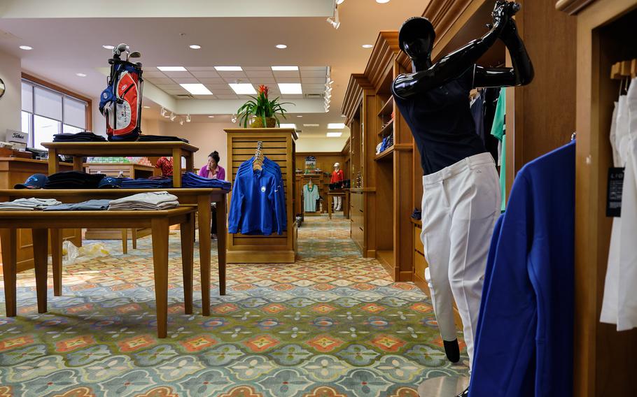 Employees stock merchandise at the pro shop inside the new River Bend Golf Course at Camp Humphreys, South Korea, March 27, 2019.