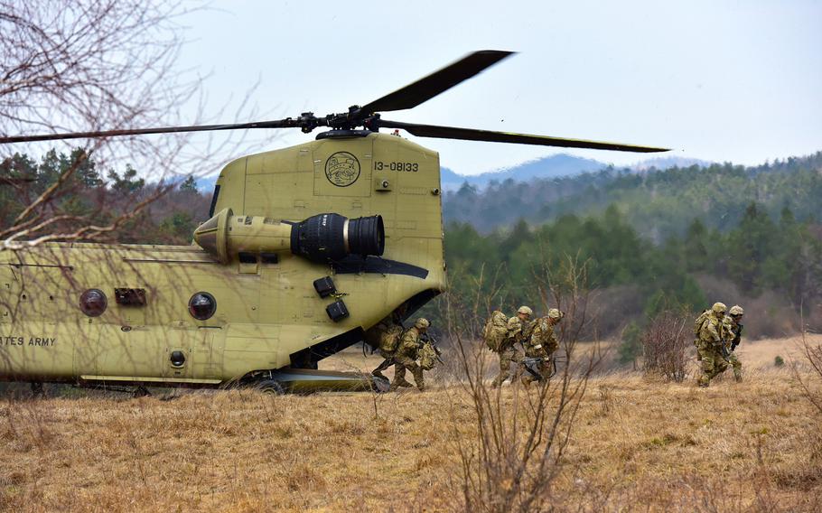 U.S. Army paratroopers assigned to 1st Battalion, 503rd Infantry Regiment, 173rd Airborne Brigade, exit from a 12th Combat Aviation Brigade CH-47 Chinook helicopter, during Exercise Eagle Sokol at Pocek Range in Slovenia, March 25, 2019.