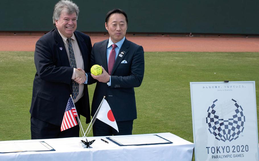 USA Softball President John Gouveia, left, and Iwakuni City Mayor Yoshihiko Fukuda pose after signing an agreement for Team USA to use the city's Atago Sports Complex to practice for the 2020 Tokyo Olympics.