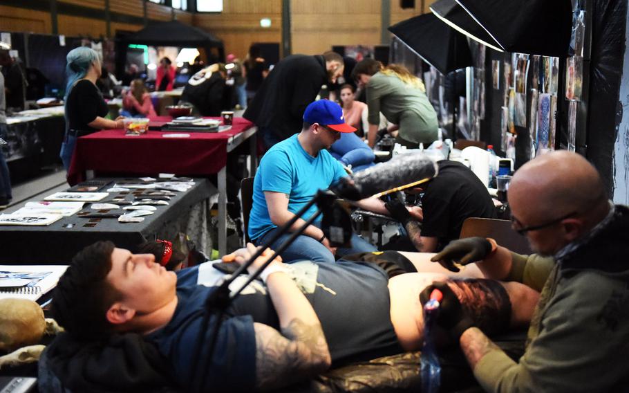 U.S. soldiers getting tattoed at the Grafenwoehr Tattoo Expo, in Grafenwoehr, Germany, Sunday, April 8, 2019.