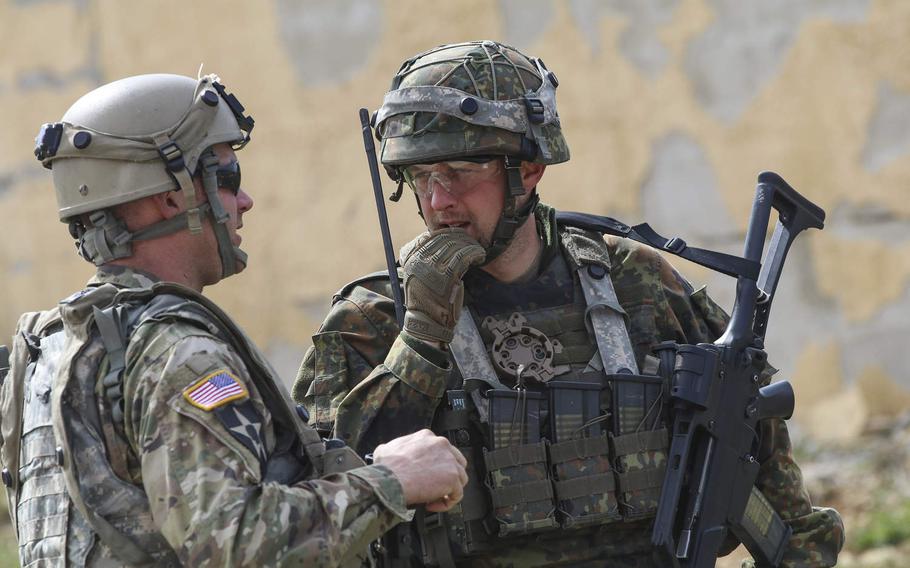 Staff Sgt. Anthony Siegenthaler, assigned to the 339th Psychological Operations Company, speaks with his German counterpart during Allied Spirit X at the Joint Multinational Readiness Center in Hohenfels, Germany, April 7, 2019.