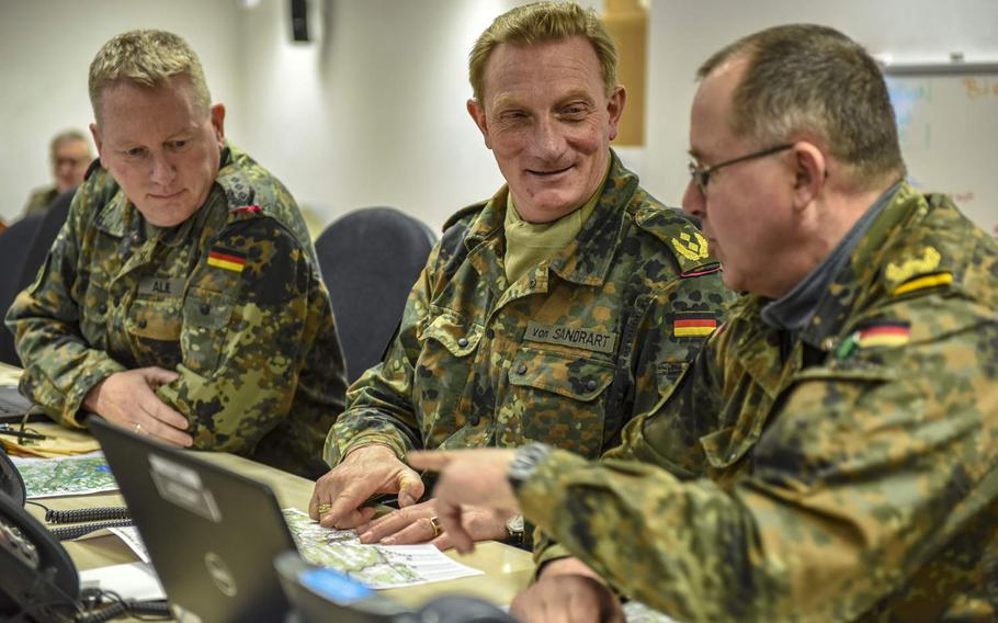 Col. Thorsten Alme, the chief of staff for 1st Armored Division of the German armed forces, Maj. Gen. Juergen-Joachim von Sandrart, the commander of the 1AD, and Brig. Dieter Meyerhoff, the deputy commander and commander of troops for 1AD, discuss operations for exercise Allied Spirit X in Hohenfels Training Area, April 4, 2019. The German unit is acting as the high command for this exercise, a first for the Allied Spirit series. Approximately 5,630 servicemembers from 15 nations are participating in the exercise.