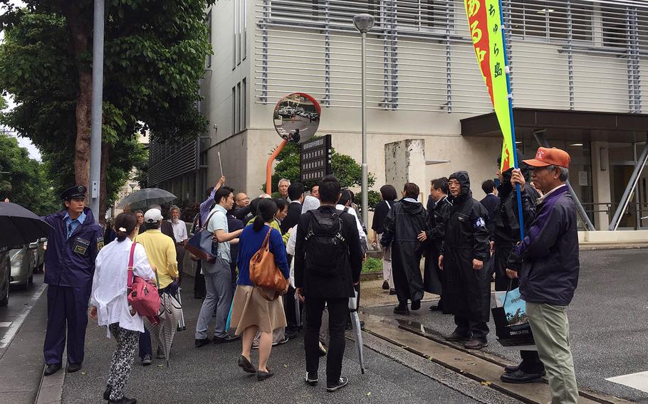 Okinawa residents who had sued over aircraft noise from Marine Corps Air Station Futenma walk toward Fukuoka High Court Naha Branch, Tuesday, April 16, 2019.