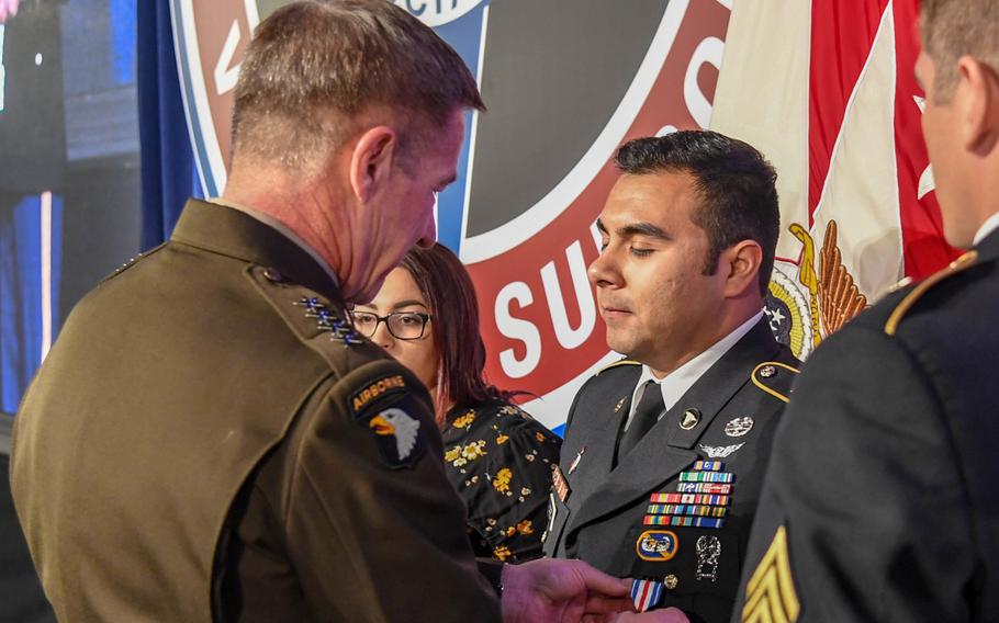 Gen. James McConville, Army vice chief of staff, presents the Silver Star to Sgt. Armando Yanez during a ceremony at the Army Aviation Association of America Summit 2019 in Nashville, Tenn., on Tuesday, April 16, 2019.