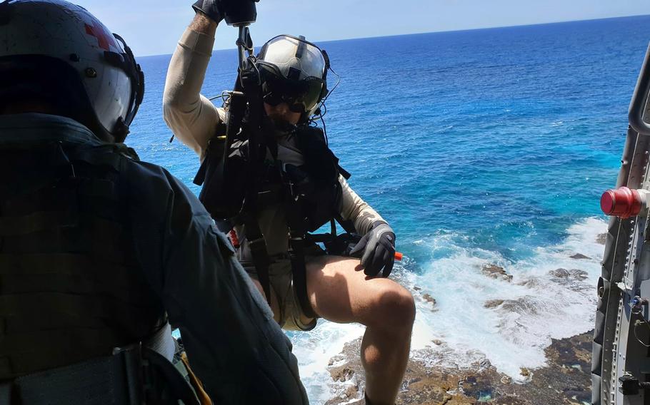 Members of the Navy's Helicopter Sea Combat Squadron 25 work to rescue two local spear fishermen whose watercraft sank off the east coast of Guam on April 11, 2019.