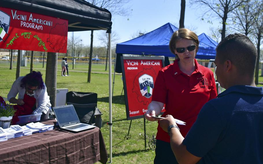 Master Sgt. Corina Cruceanu, one of the Vicini Americani program managers, speaks with a potential volunteer during the Spring Into Spring Festival at Aviano Air Base's Freedom Park, April 19, 2019. Some of the program?s goals are to foster friendship and cooperation among Americans and Italians living as neighbors in the surrounding communities.