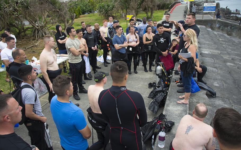 Gunnery Sgt. Scott Dahn and his wife, April Dahn, owners of Mermaid Island Diving, speak to volunteer scuba divers and snorkelers during an ocean cleanup event in Chatan, Okinawa, Saturday, April 20, 2019.