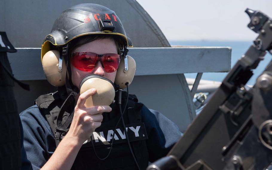 Seaman Emily Tate, an aviation ordnanceman from McKinney, Texas, uses a sound-powered phone while standing watch aboard the aircraft carrier USS John C. Stennis in the Suez Canal, April 20, 2019.