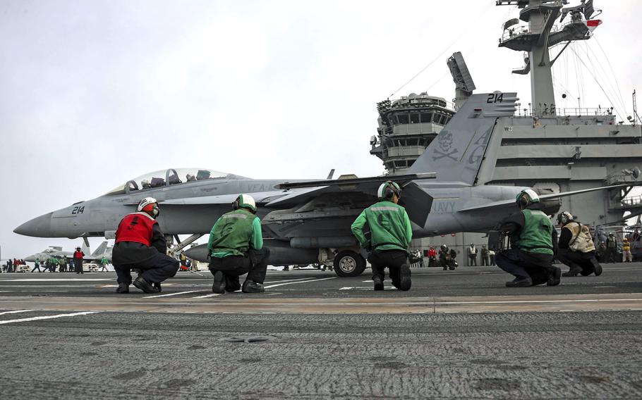 Sailors prepare to launch an F/A-18F Super Hornet from the flight deck of the aircraft carrier USS Abraham Lincoln in the Mediterranean Sea, April 21, 2019.