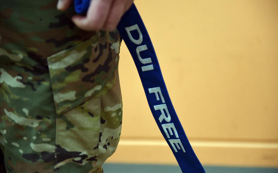A "No DUI Streamer"  being held by a 2nd Cavalry Regiment soldier during a ceremony, Friday, April 19, 2019.