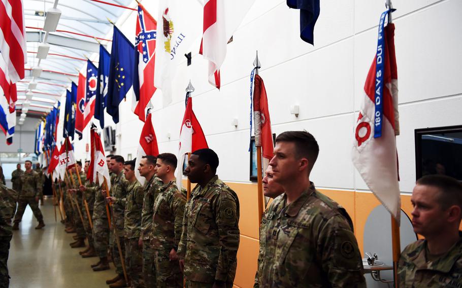 Soldiers with the Army's 2nd Cavalry Regiment during a ceremony to fix "No DUI Streamer"  to squadrons' guidons Friday, April 19, 2019.