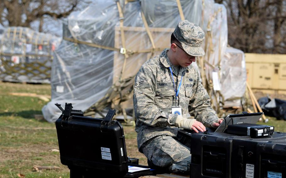 Airman 1st Class Harry Randazzo, 1st Combat Communications Squadron, Ramstein Air Base, Germany, prepares equipment for expeditionary medical support facilities at Cincu Military Base, Romania, April 4, 2019, during exercise Vigorous Warrior 19.