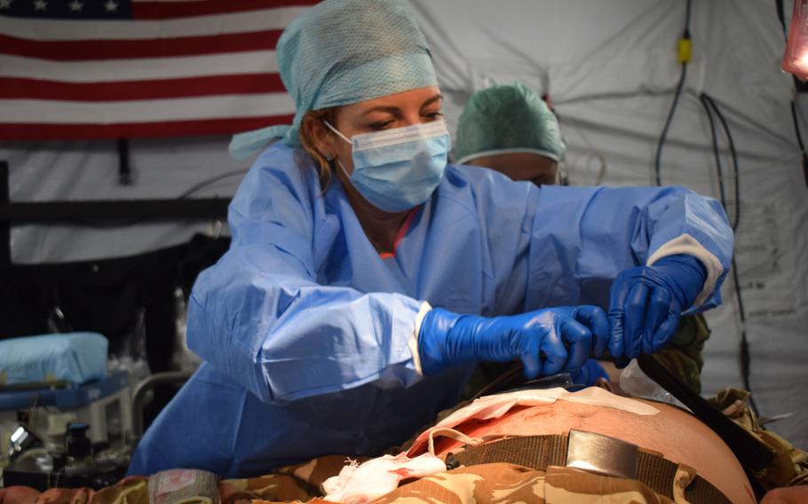 Cristina Prodan, chief nurse, Military Hospital Timisoara, Romania, participates in a multinational surgical exchange drill at the U.S. Air Force 86th Medical Group Role 2 field hospital during Vigorous Warrior 19, Cincu Military Base, Romania, April 11, 2019.