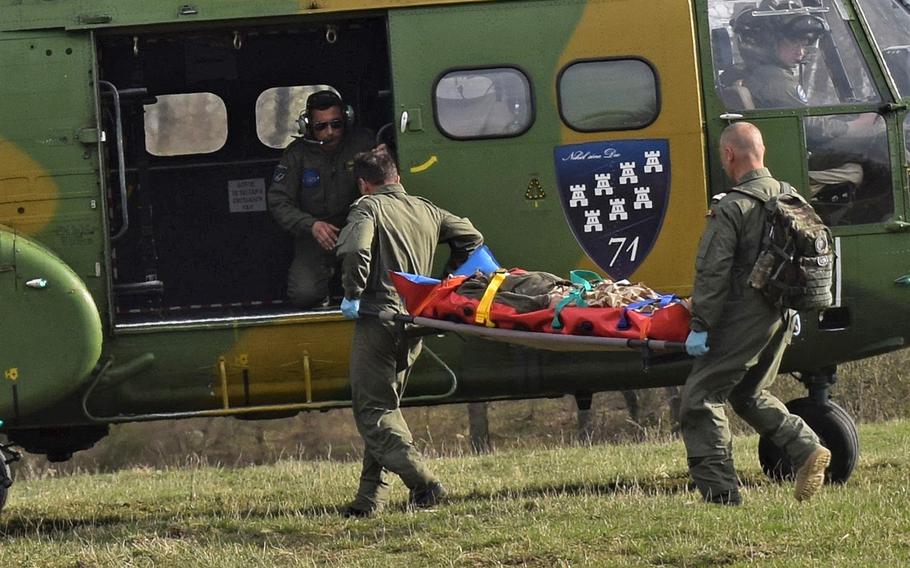 A Romanian aircrew performs a medical evacuation drill at the Role 2 field hospital maintained by airmen from the 86th Medical Group, Ramstein Air Base, Germany, during Vigorous Warrior 19, Cincu Military Base, Romania, April 8, 2019. Vigorous Warrior 19 is NATO's largest-ever military medical exercise.