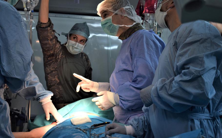 Maj. Lindsey Marquez, a nurse anesthetist, 86th Medical Group, Ramstein Air Base, Germany, and Maj. Florin Buia, general and vascular surgeon, Cluj-Napoca Emergency Military Hospital in Romania, participate in a multinational surgical exchange drill during Vigorous Warrior 19, Cincu Military Base, Romania, April 11, 2019.