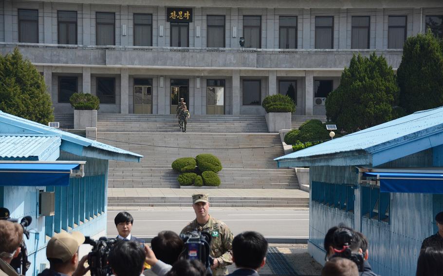 North Korean soldiers march down the steps on their side of the Joint Security Area as Army Lt. Col. Sean Morrow, commander of the United Nations Command Security Battalion, speak to reporters on the south side of the Panmunjom truce village, Wednesday, May 1, 2019.