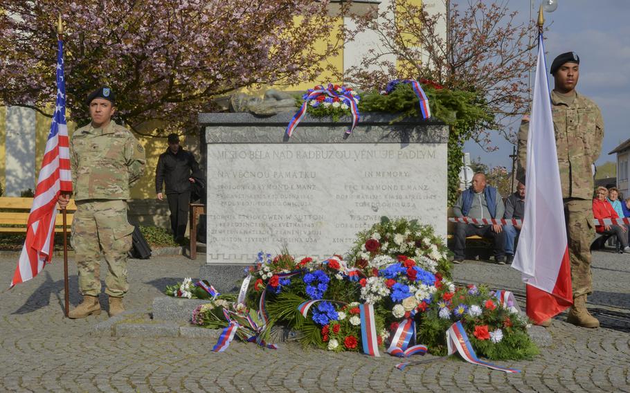 U.S. soldiers from the 2nd Cavalry Regiment  stand at attention with the American and Czech flags during the 74th anniversary of Operation Cowboy at the Bela Town Square, Bela, Czech Republic, on Tuesday, April 30, 2019.
