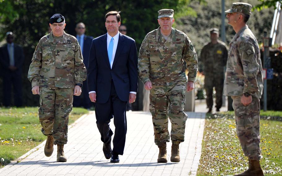U.S. Army Gen. Curtis M. Scaparrotti, Army Secretary Mark T. Esper and Air Force Gen. Tod D. Wolters enter the parade grounds at the beginning of the U.S. European Command change of command ceremony in Stuttgart, Germany, Thursday, May 2, 2019. Wolters took over the command from Scaparrotti at the ceremony.