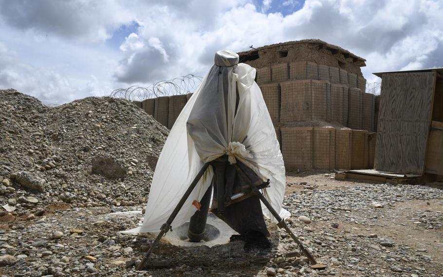 Afghan soldiers dress up a mortar emplacement in a makeshift burka at a remote outpost in Helmand province, the deadliest province in the country for Talban attacks in 2018. A Taliban infiltrator killed three soldiers at another outpost of the Afghan 215th Corps in Helmand, on April 15, 2019.