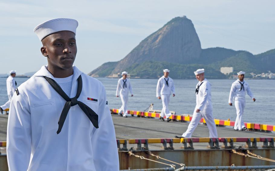 Sailors man the rails aboard the amphibious assault ship USS Wasp as the ship prepares to moor in Rio de Janeiro in 2017. President Donald Trump said he will grant special military status to Brazil, making it a ''major non-NATO ally'' in a move to boost cooperation. In the background is Rio's famed Sugarloaf Mountain.