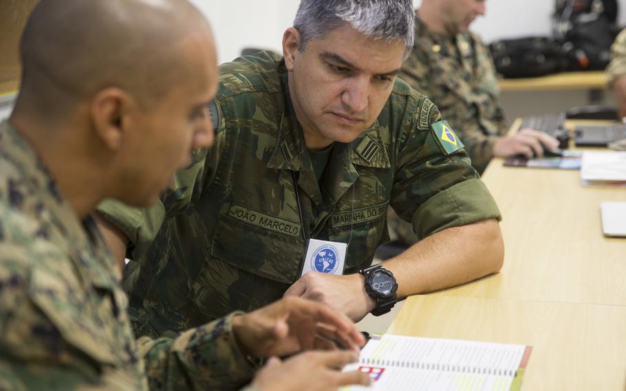 Brazilian naval infantry Lt. Col. Joao Marcelo Batista speaks with U.S. Marine Capt. Jose Negrete, the communication strategy and operations director with U.S. Marine Corps Forces, South, in Rio de Janeiro, Brazil in August 2018. President Donald Trump said he will grant special military status to Brazil, making it a ''major non-NATO ally'' in a move to boost cooperation.