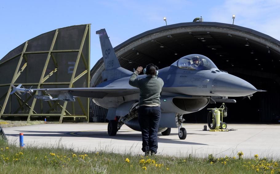 U.S. Air Force Staff Sgt. Reina Baker, 52nd Aircraft Maintenance Squadron, directs the departure of an F-16 Fighting Falcon flown by Maj. Kevin Bunten, 480th Fighter Squadron, before a low-level training sortie at RAF Lossiemouth, Scotland, May 7, 2019. 