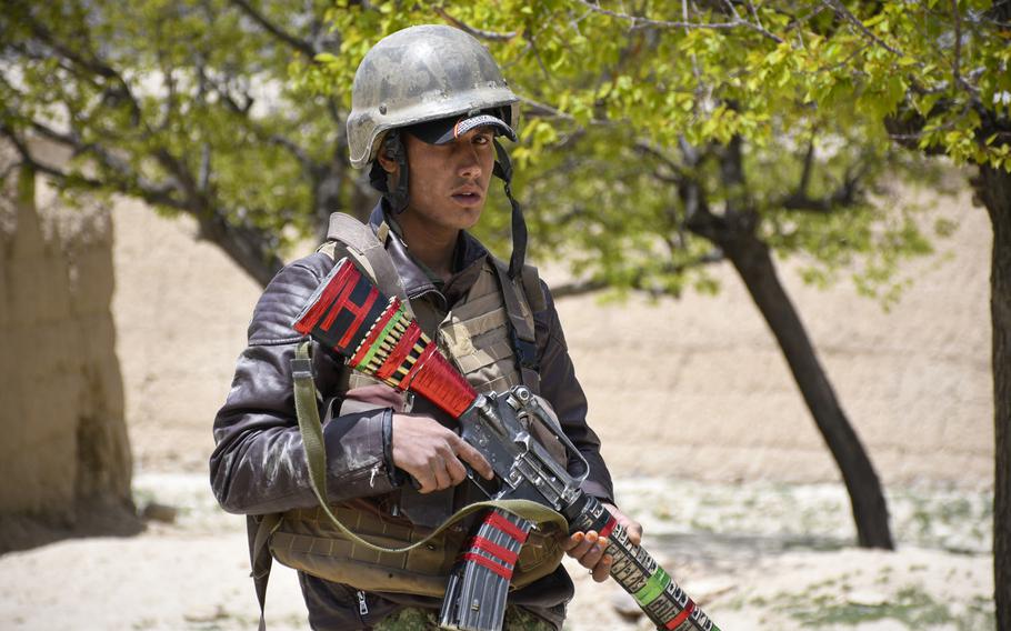 An Afghan soldier guards a temporary checkpoint in Logar province on May 2, 2019. Almost half of Afghan troops killed or wounded last year were defending small checkpoints such as this one.