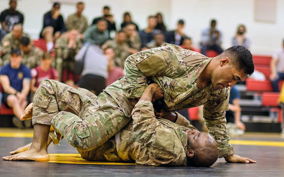 Pfc. Frazer Taua, top, and Sgt. Daquon Jeffress of 2nd Infantry Division compete during the Friday Night Fights debut tournament at Camp Humphreys, South Korea, on May 10, 2019.